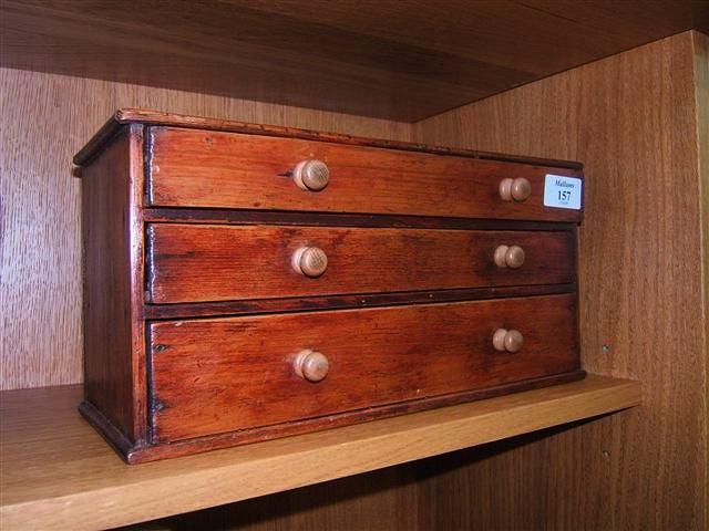 Appraisal: A miniature pine Collector's chest of three drawers wide