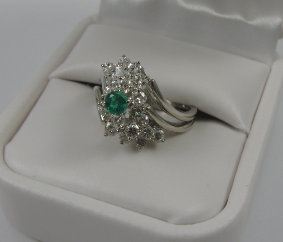 Appraisal: EMERALD DIAMOND AND K WHITE GOLD CLUSTER RING set with