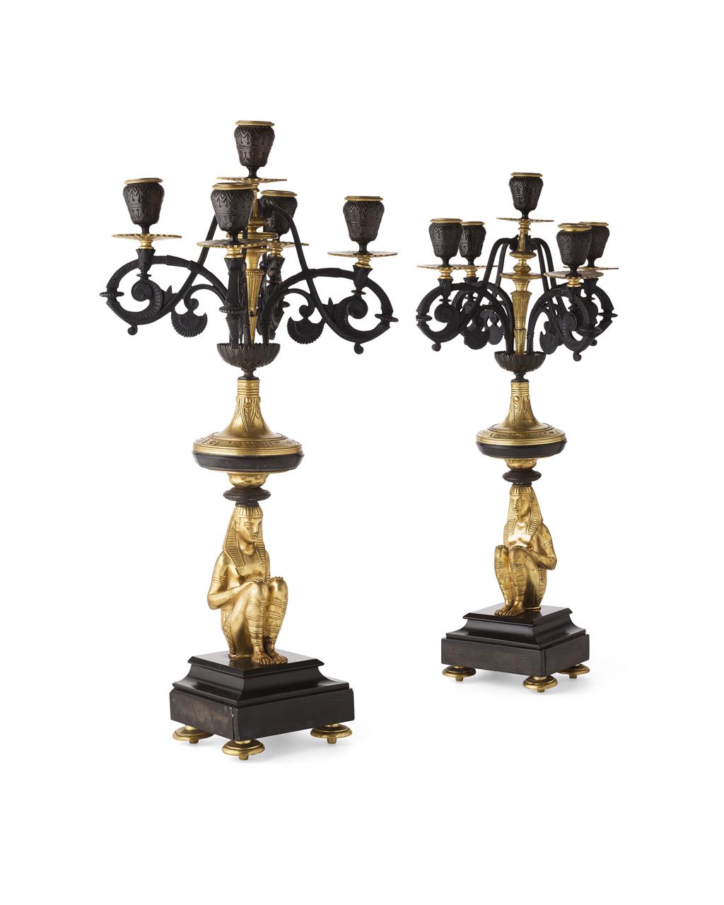 Appraisal: PAIR OF GILT AND PATINATED BRONZE EGYPTIAN REVIVAL FIGURAL CANDELABRA