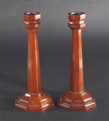 Appraisal: A pair of Arts and Crafts sycamore candlesticks on stepped