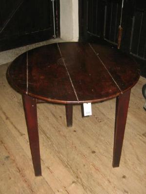 Appraisal: AN OAK CRICKET TABLE with plank top plain frieze and