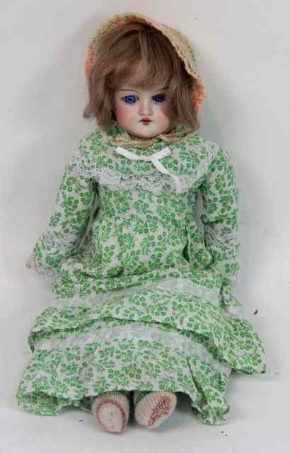 Appraisal: A bisque headed doll A M D with cloth body