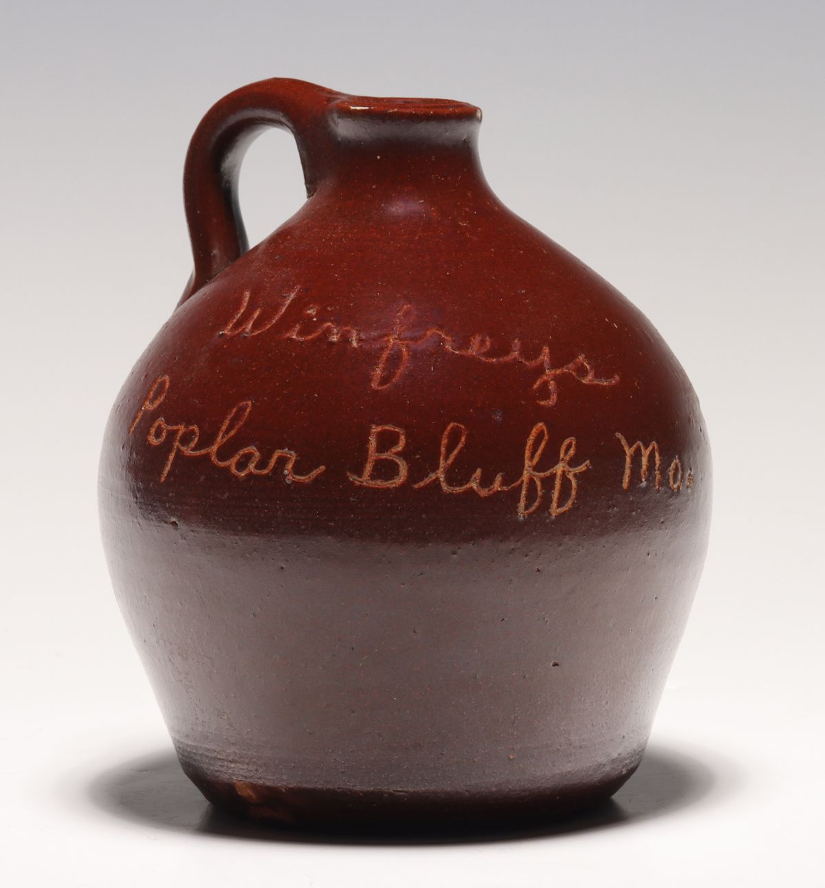 Appraisal: ANTIQUE SCRATCH JUG LETTERED WINFREY'S POPLAR BLUFF MOThe condition is