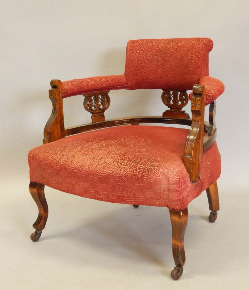 Appraisal: An Edwardian oak tub shaped chair with a padded back