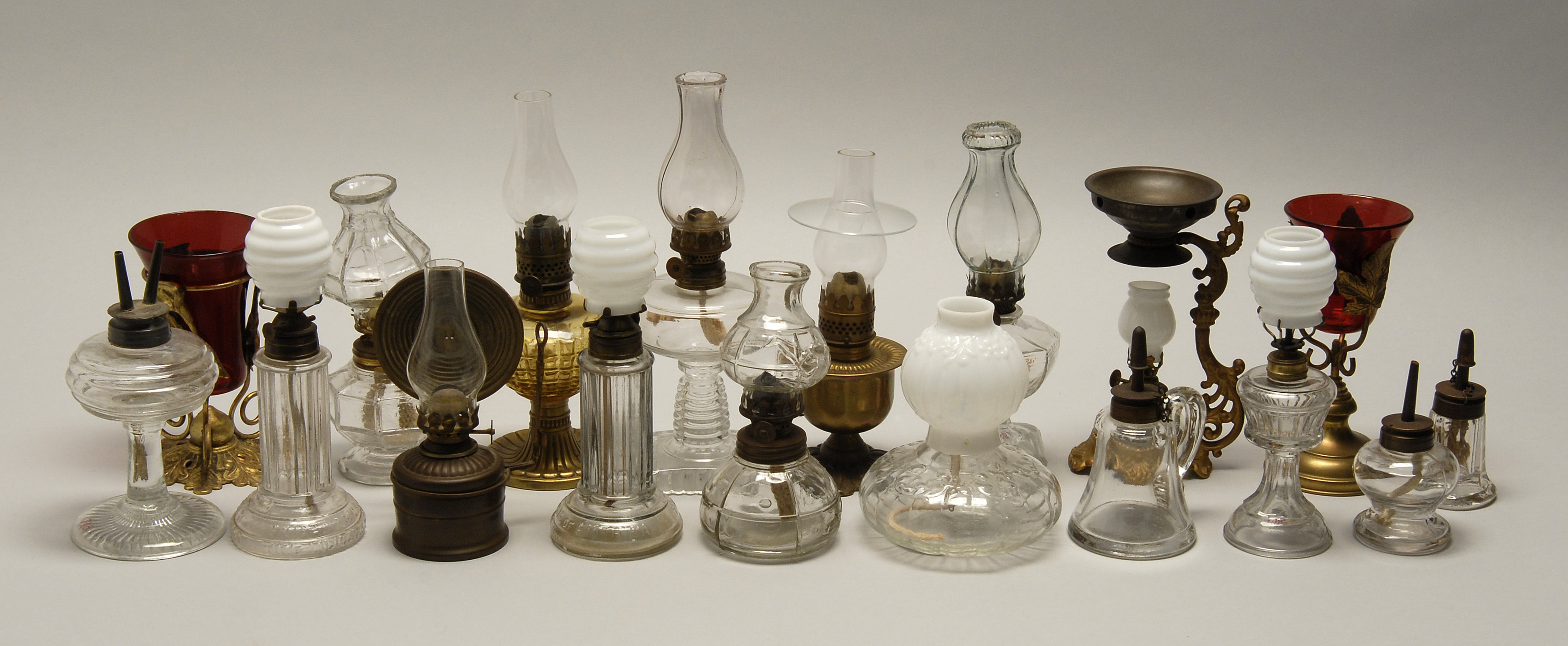 Appraisal: EIGHTEEN ASSORTED MINIATURE LAMPS Twelve are clear glass six are