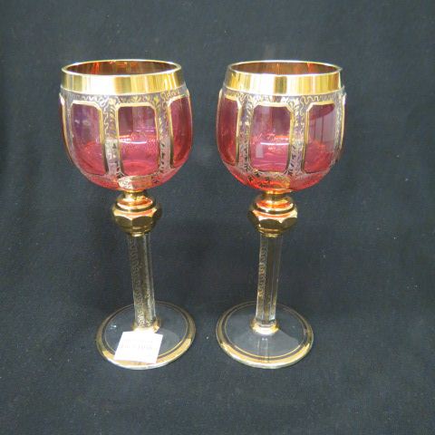 Appraisal: Pair of Moser Cranberry Glass Goblets cathedral pattern elaborate goldwork