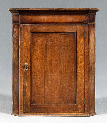 Appraisal: Georgian oak hanging corner cupboard molded cornice single panel door