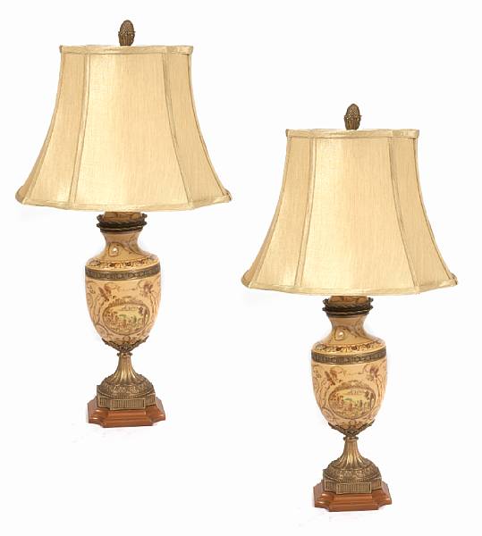 Appraisal: A pair of gilt metal mounted earthenware table lamps height