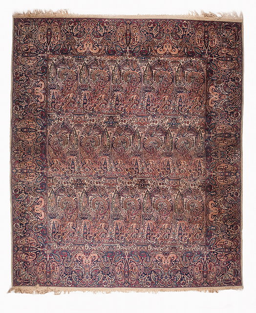 Appraisal: A KIRMAN WHITE GROUND CARPET decorated three rows of accentuated