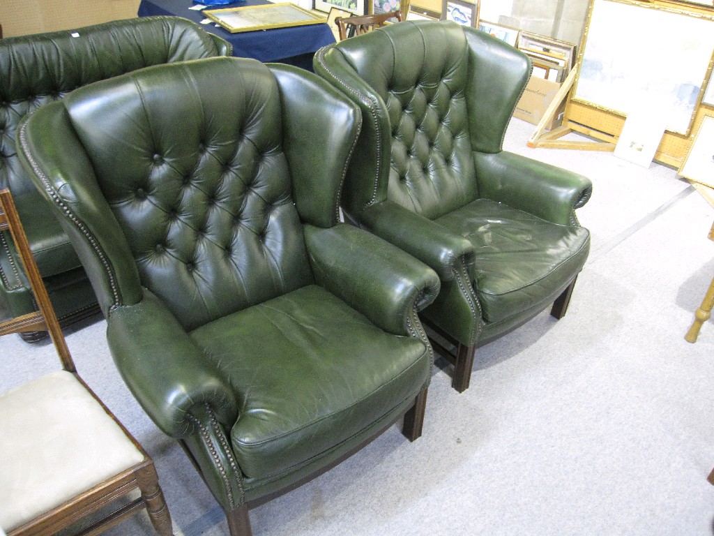 Appraisal: Pair of green leather Chesterfield style wingback armchairs