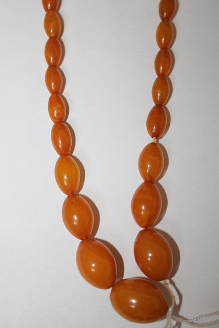 Appraisal: A GRADUATED AMBER NECKLACE of honey colour grams beads