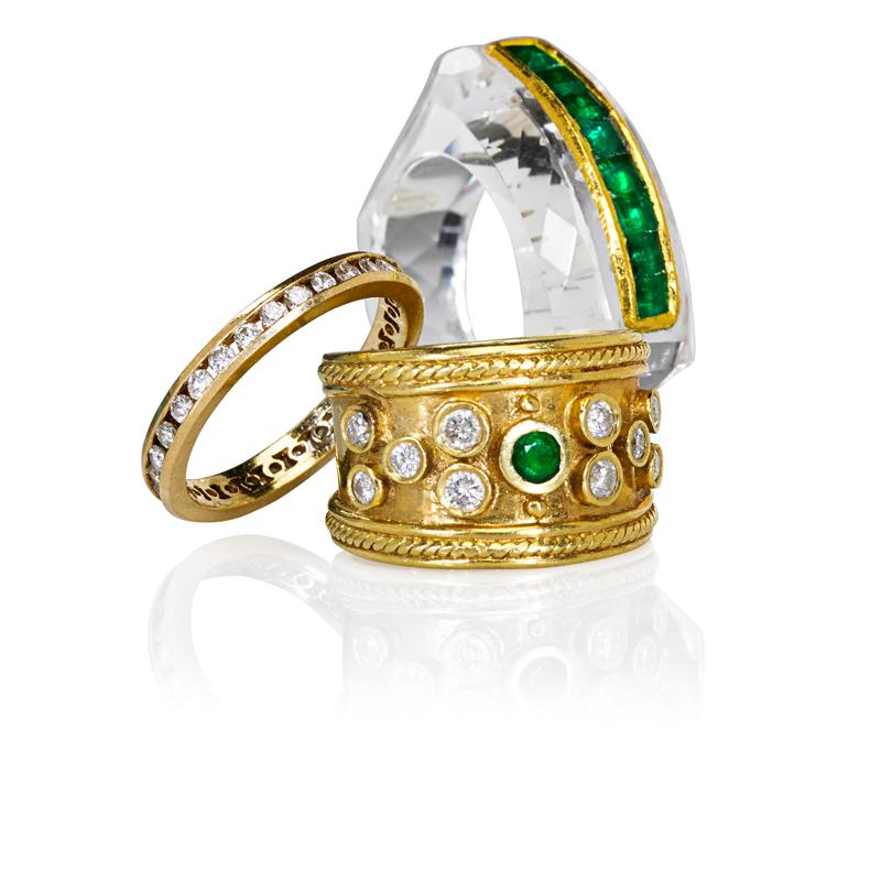 Appraisal: THREE YELLOW GOLD DIAMOND OR EMERALD RINGS Carved rock crystal