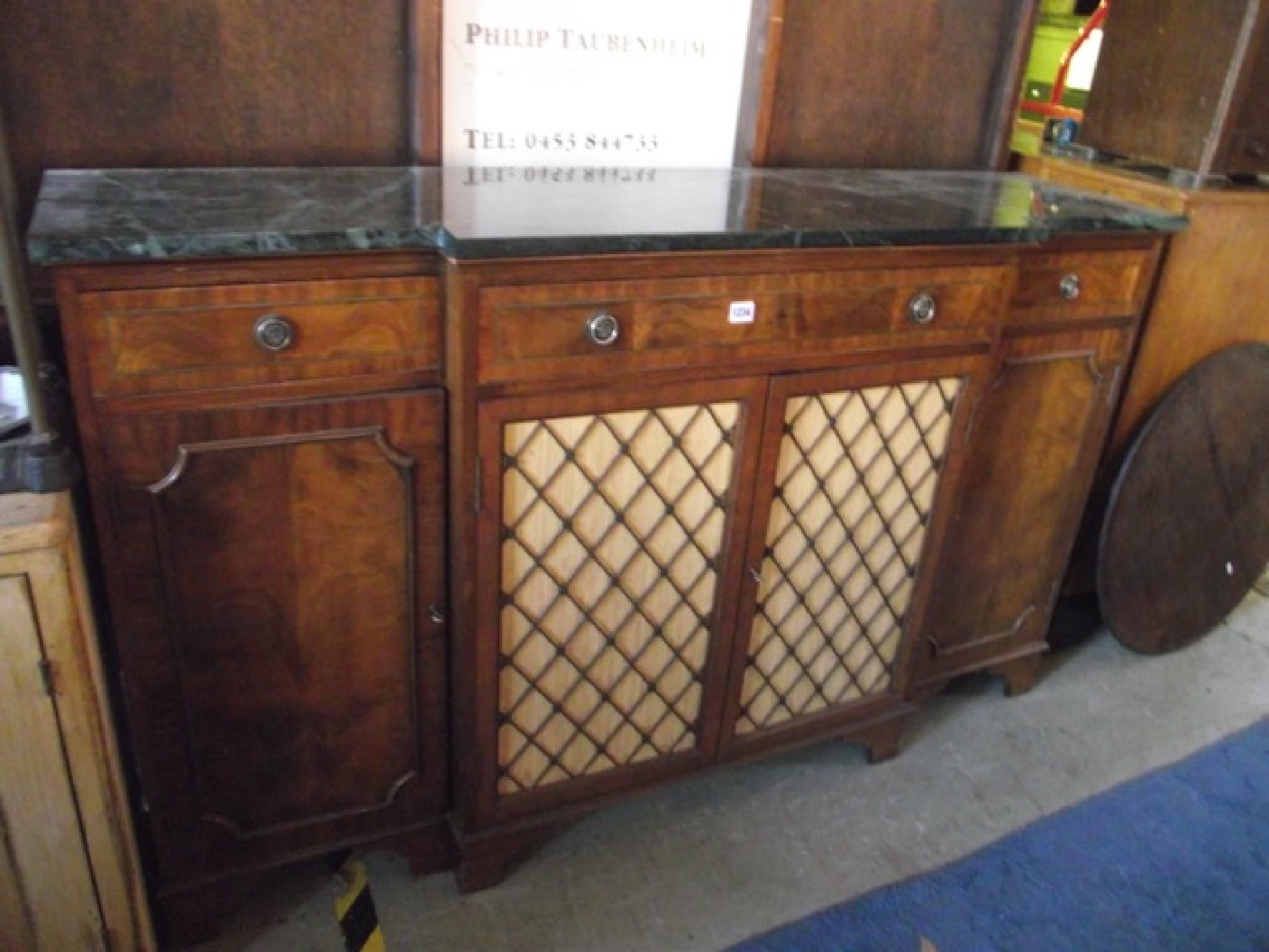 Appraisal: A good quality reproduction mahogany breakfront side cupboard in the