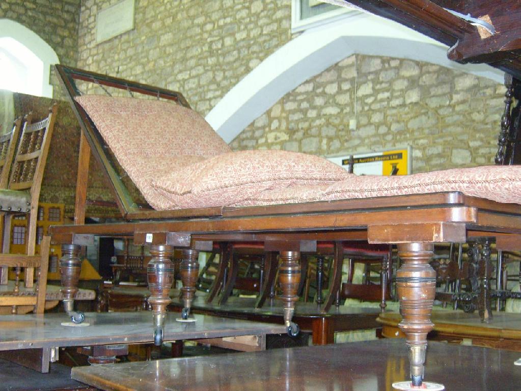 Appraisal: An Edwardian walnut adjustable day-bed with turned supports