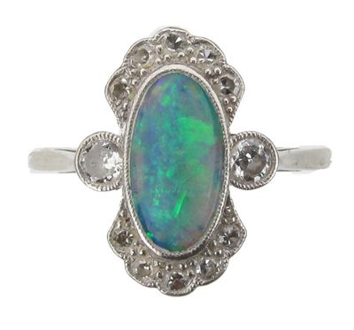 Appraisal: An Edwardian opal and diamond ring The oval shaped solid