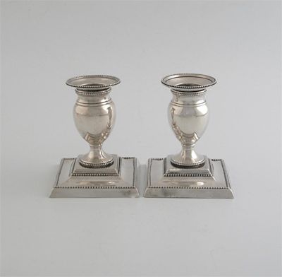 Appraisal: A pair of George III bureau candlesticks with detachable drip