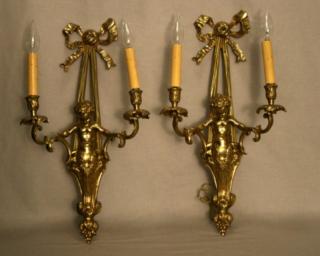 Appraisal: PAIR OF PUTTI POLISHED BRONZE LIGHT SCONCES PAIR OF PUTTI