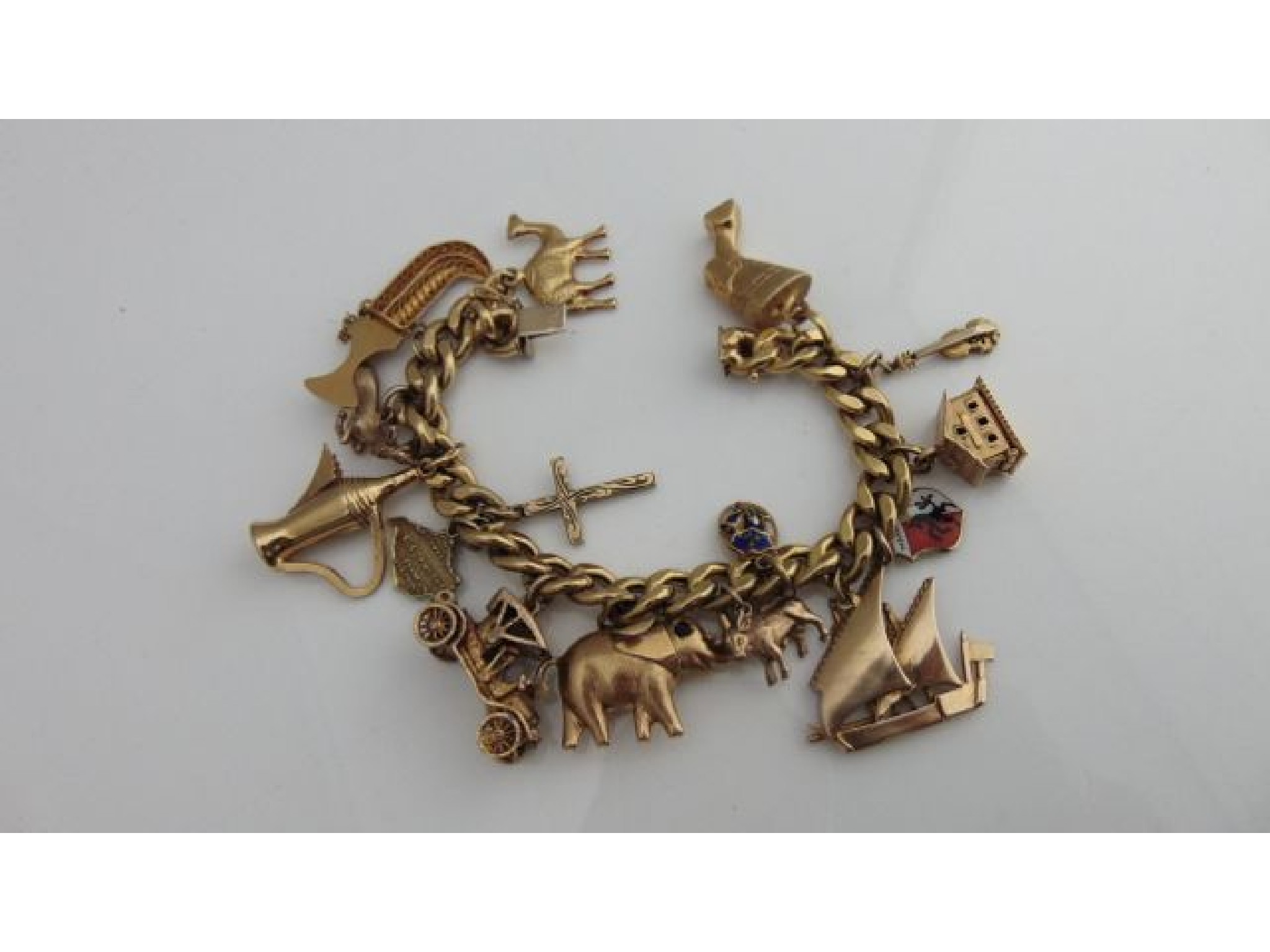 Appraisal: An ct gold charm bracelet suspended with fifteen various charms