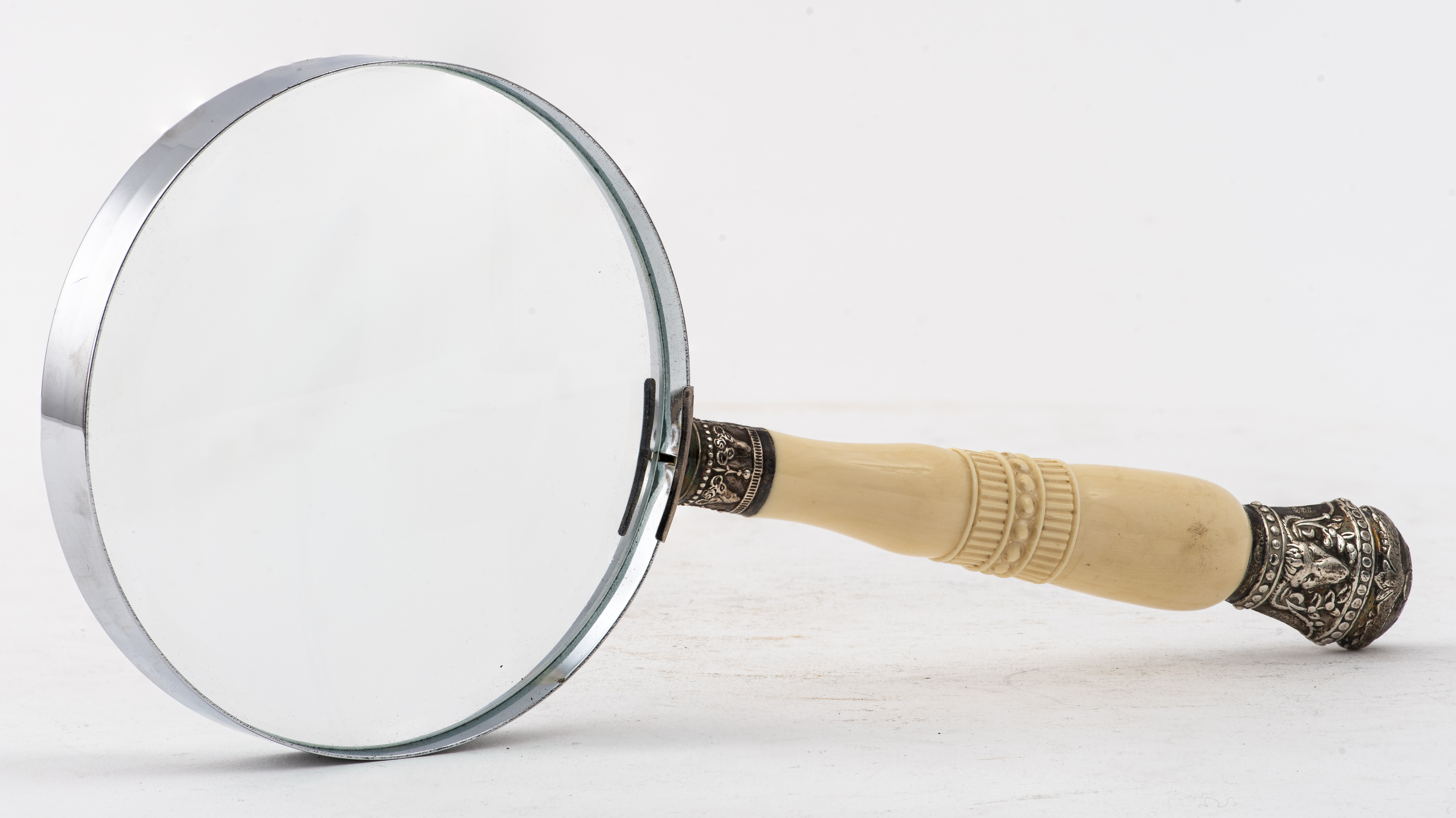 Appraisal: STERLING BONE-HANDLED BUCRANIUM MAGNIFYING GLASS Magnifying glass with a handle