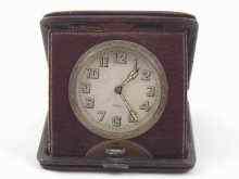 Appraisal: A leather cased travelling clock circa dial approx cm diameter