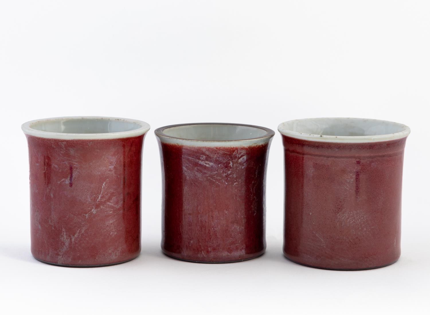 Appraisal: THREE CHINESE OXBLOOD PORCELAIN BRUSH POTS Three Chinese Oxblood glazed