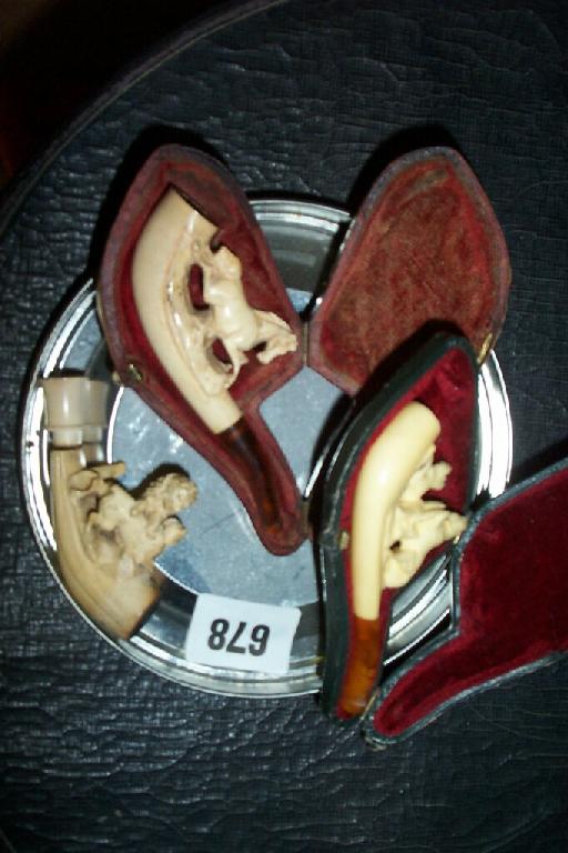 Appraisal: Three Meerschaum cheroot holders cased with horse dog and lion