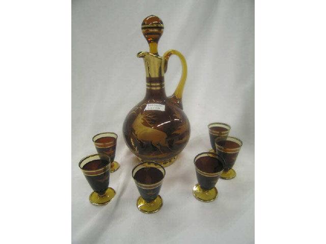 Appraisal: Art Glass Decanter Cordial Set deep ruby gold etched stag