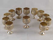 Appraisal: A set of twelve embossed silver tot cups each marked