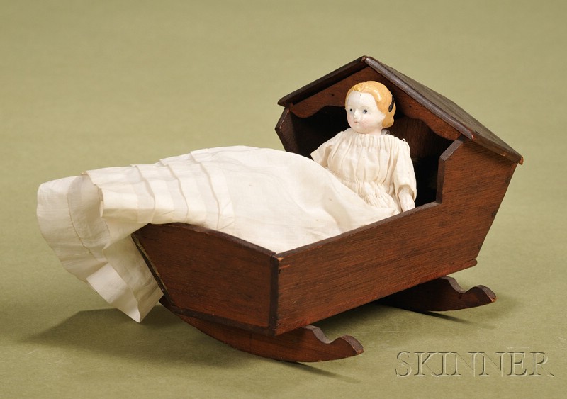 Appraisal: Squeak Toy Child with Cradle c the German doll with