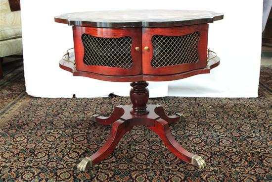 Appraisal: DRUM TABLE Red leather shaped top wire mesh doors and