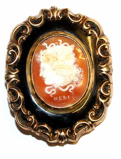 Appraisal: A VICTORIAN ENAMELLED MOURNING BROOCH with an inset cameo of