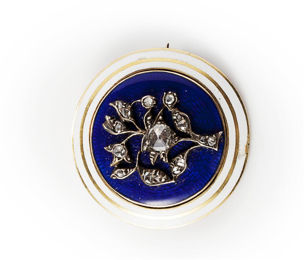 Appraisal: A diamond and enamel set brooch of circular outline modelled