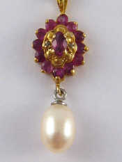 Appraisal: A carat gold ruby and freshwater pearl pendant and chain