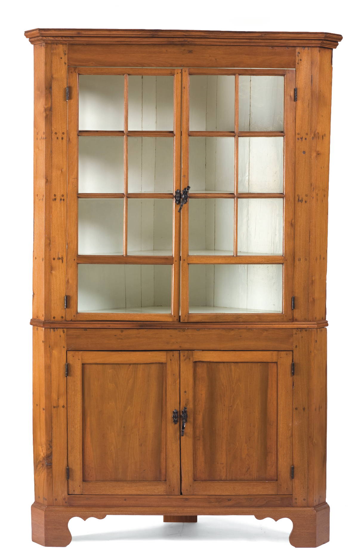 Appraisal: AMERICAN WALNUT TWO-PART CORNER CUPBOARD The upper part with molded