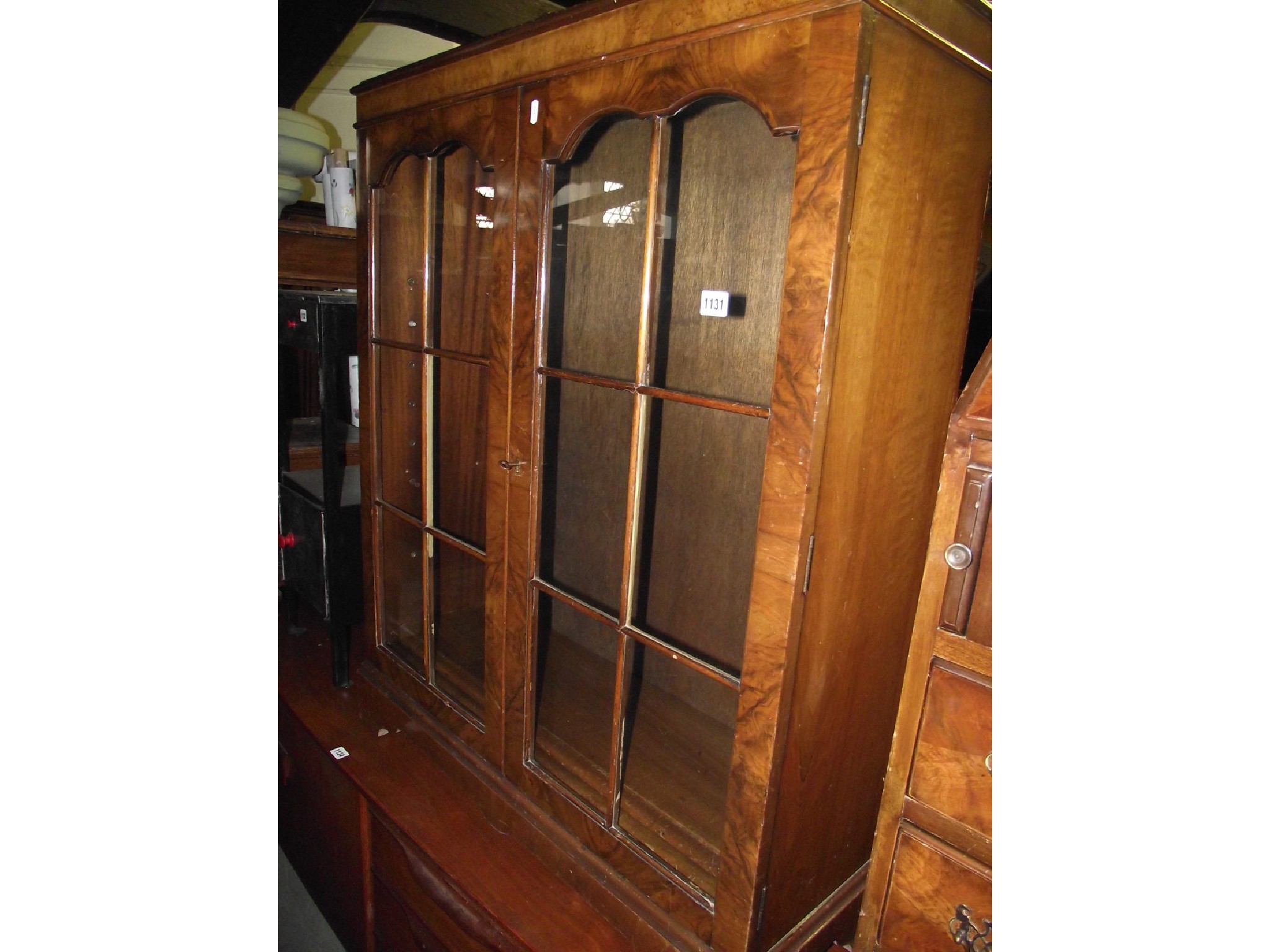 Appraisal: A small reproduction walnut and figured walnut veneered bookcase enclosed