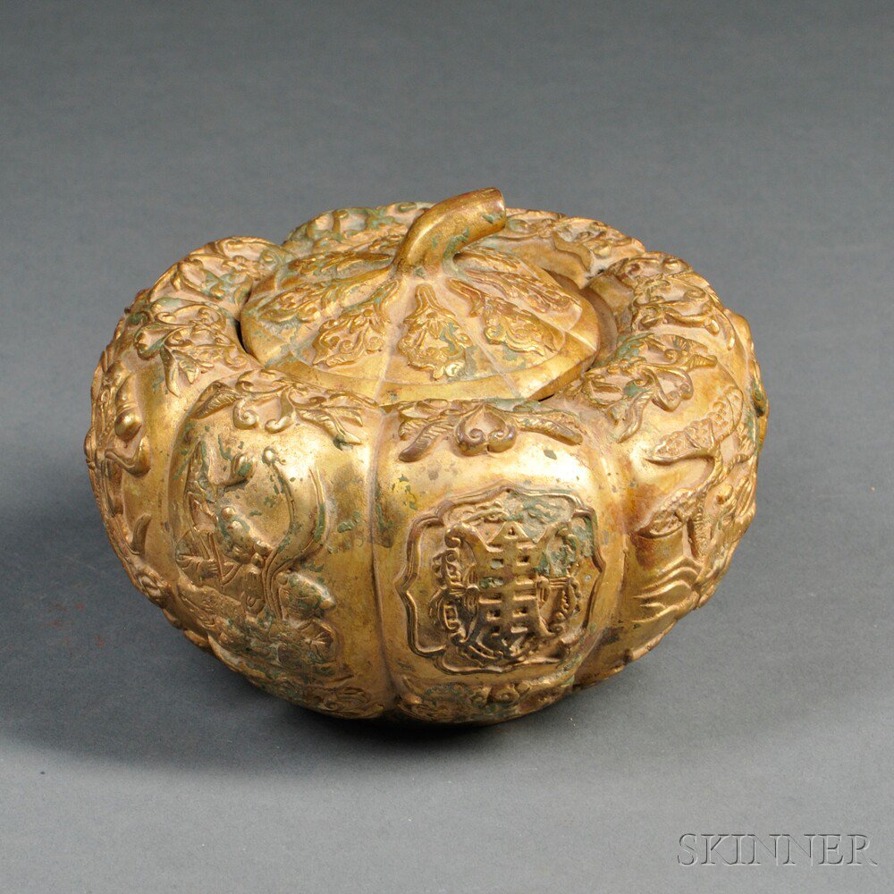 Appraisal: Gilt-metal Covered Vessel China pumpkin shape decorated with Immortals and