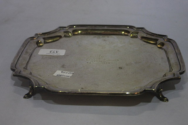 Appraisal: A SILVER SALVER with canted pie-crust border cabriole supports and