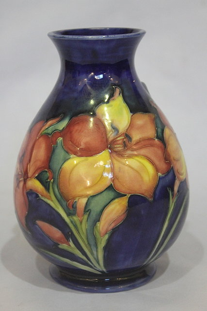 Appraisal: A MOORCROFT COBALT BLUE GROUND BALUSTER VASE with freesia decoration