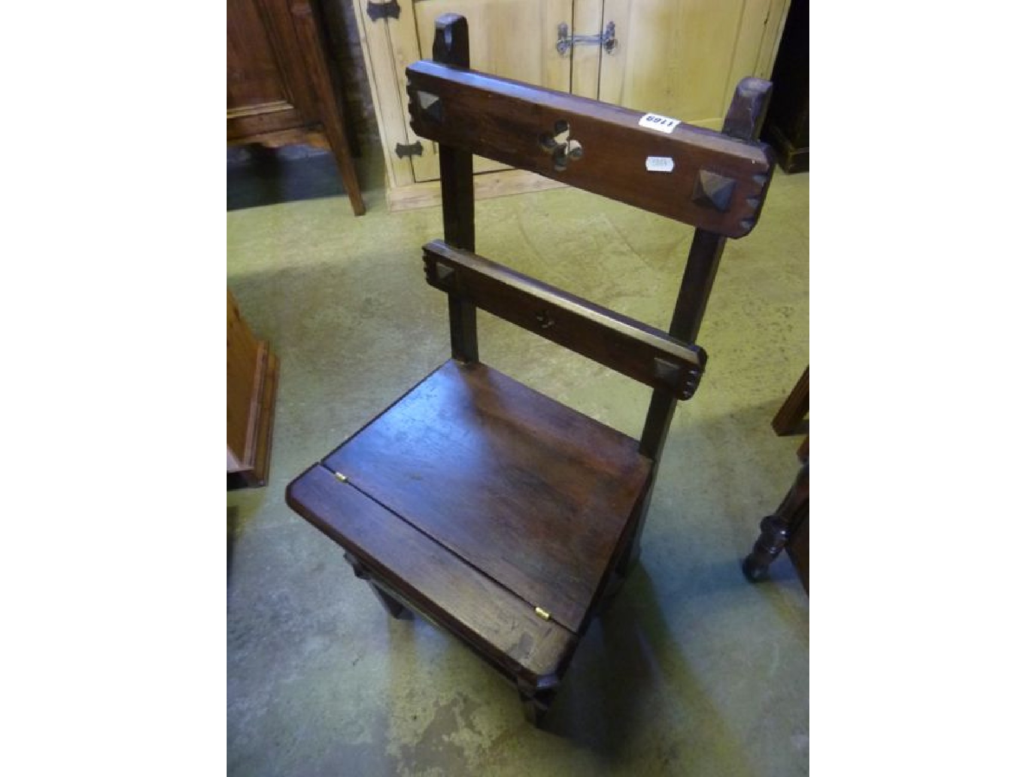 Appraisal: A metamorphic stained hardwood chair steps with gothic tracery detail