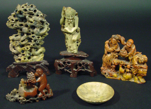 Appraisal: Four oriental soapstone figural carvings and a soapstone dish the