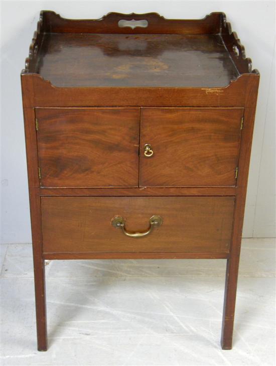 Appraisal: th century mahogany tray top commode with cupboard over a