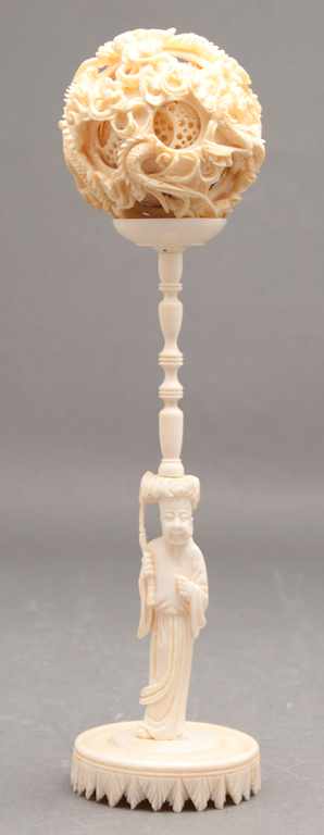 Appraisal: Chinese carved ivory puzzle ball and a figural carved stand