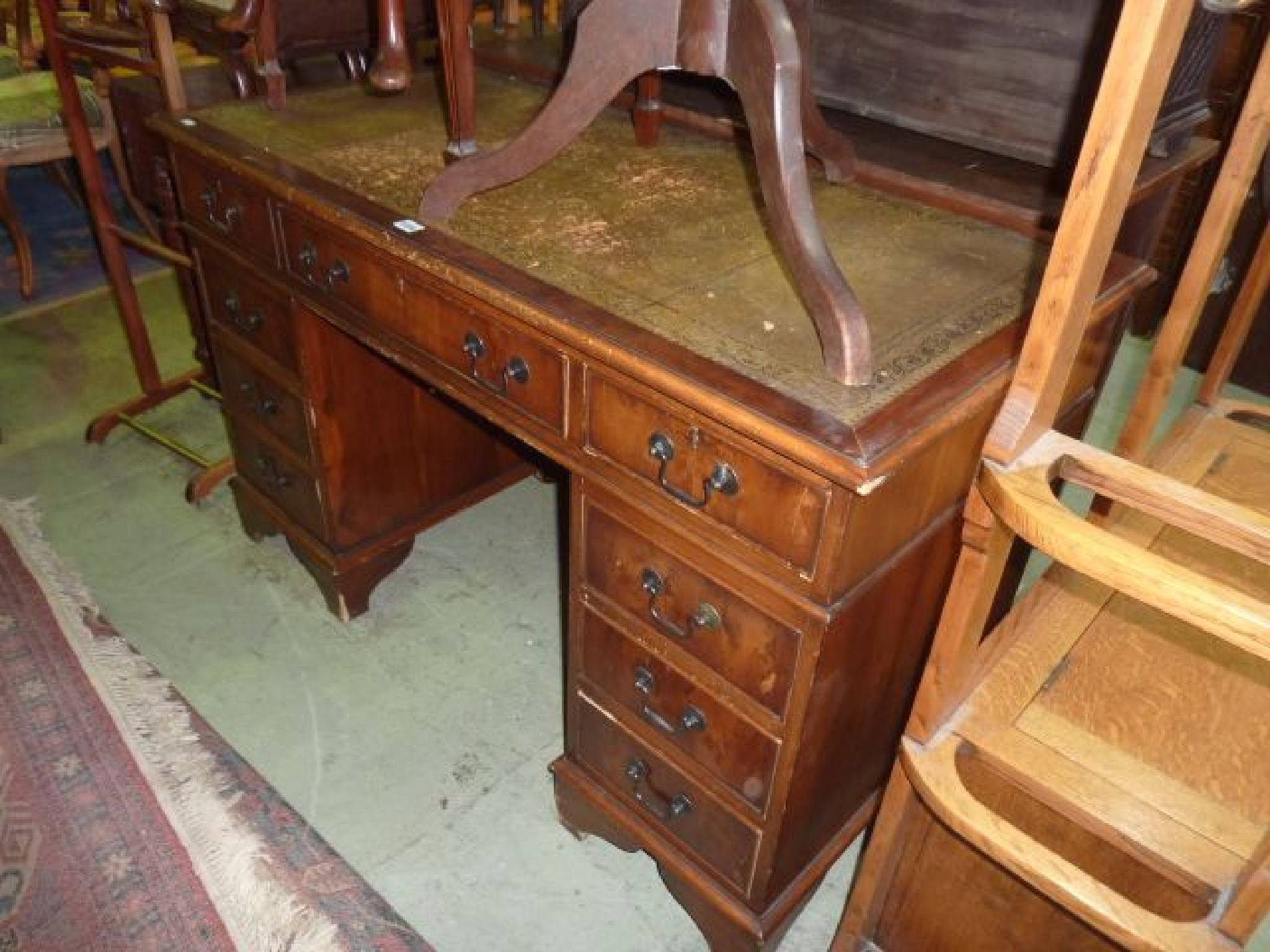 Appraisal: A Georgian style walnut pedestal desk fitted with nine drawers