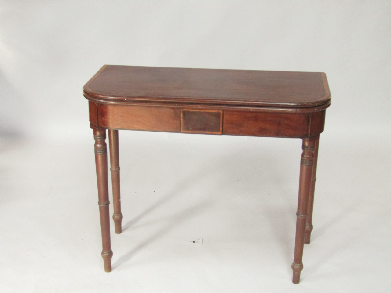 Appraisal: A George IV mahogany and satinwood cross banded foldover card