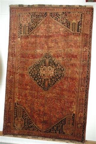 Appraisal: A QASHGAI RUST GROUND RUG with central medallion motif within