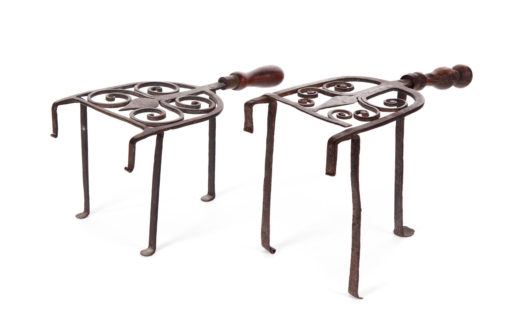 Appraisal: TWO AMERICAN WROUGHT IRON KETTLE STANDS Nineteenth century Similar scrolled