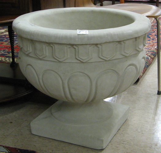 Appraisal: A PAIR OF CAST CONCRETE GARDEN PLANTERS each a round