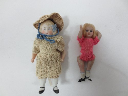 Appraisal: A bisque doll with moulded hair and blue ribbon having