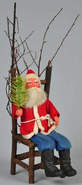 Appraisal: Large Santa Sitting on Early Putz Chair Description Depicts Santa