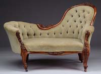 Appraisal: CARVED WALNUT VICTORIAN RECAMIER The two seat sofa has flower